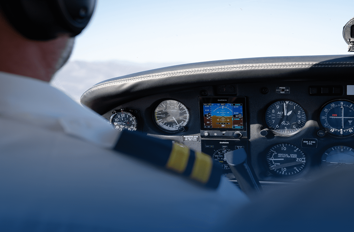 Airplane cockpit view with pilot and controls