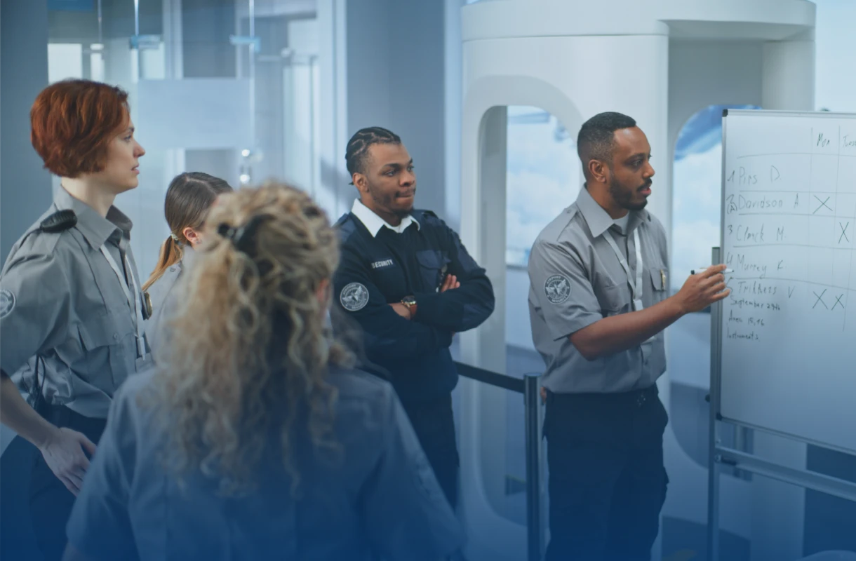 Security team meeting at whiteboard