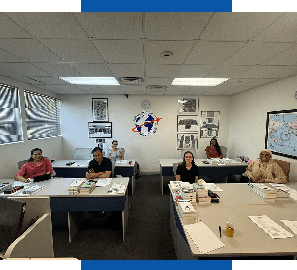 Adults seated in classroom with aviation logo