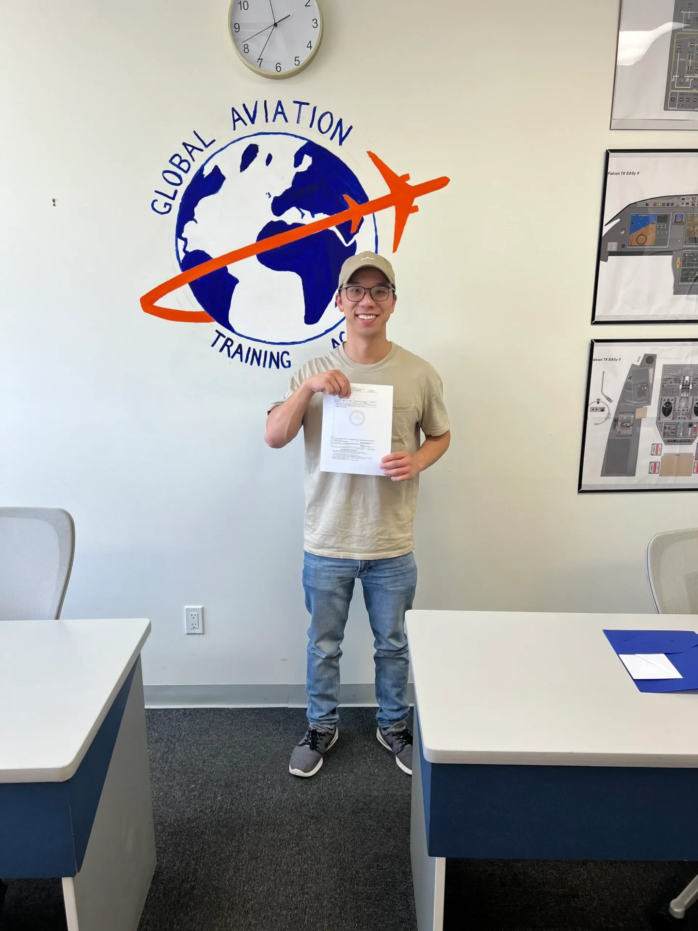 Smiling person holding certificate by aviation logo