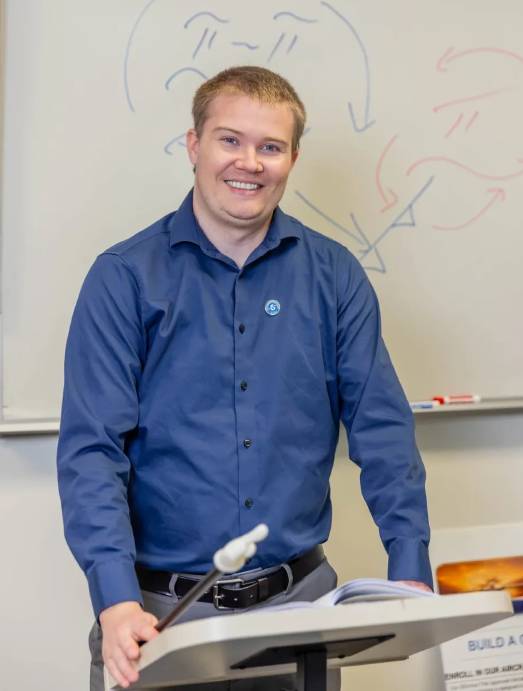 Smiling man standing at a lectern