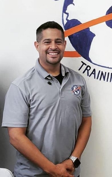 Smiling man in gray polo shirt